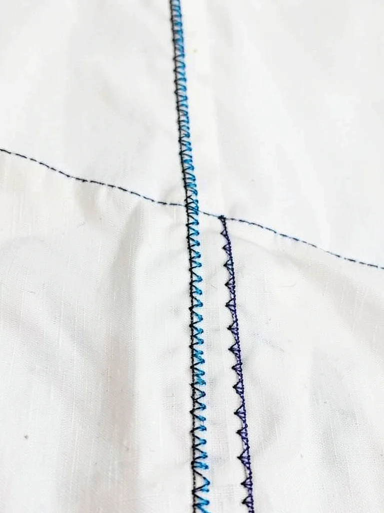 Side seam embroidery — narrow protective band running down garment side seam
