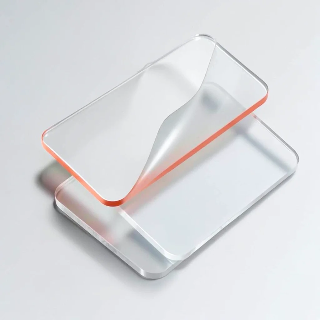 Stacked trio of translucent badge passes offset diagonally, top sheet curling to