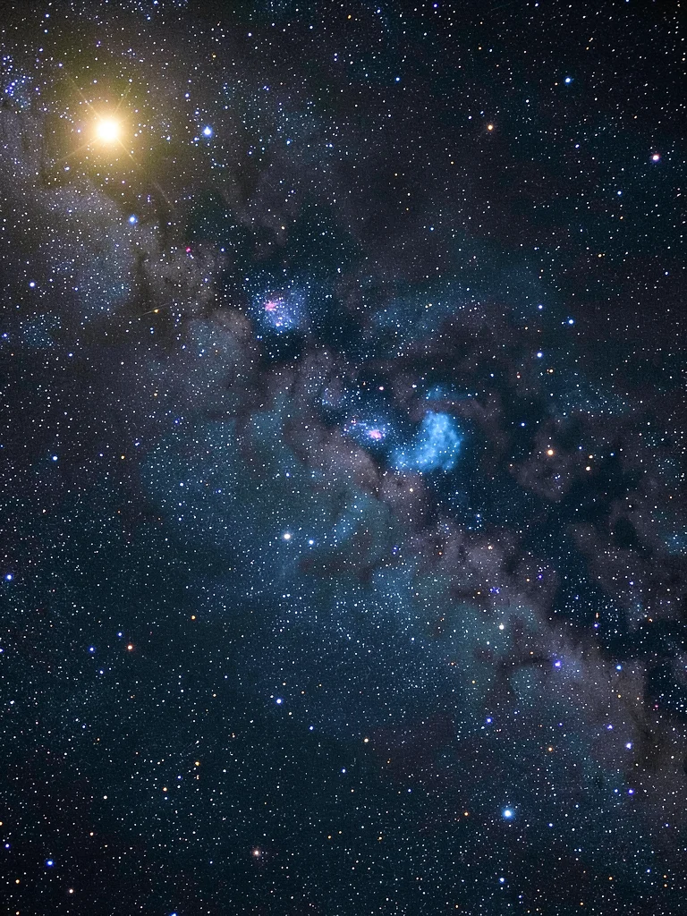 A reflection nebula — blue-lit cloud of dust reflecting a nearby hot star, the s