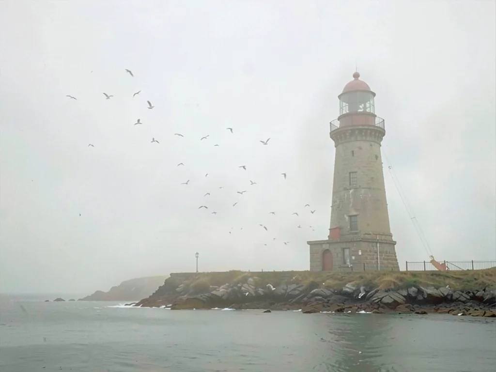 Stub stone lighthouse on a low spit, gulls implied as small scuffs in the air, t