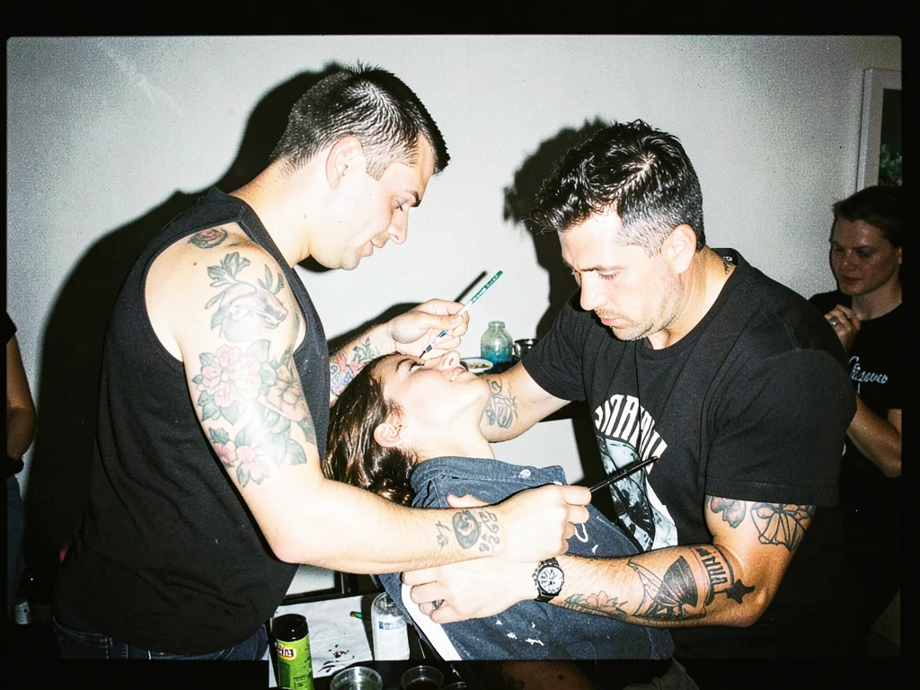 Tattoo artist working on client