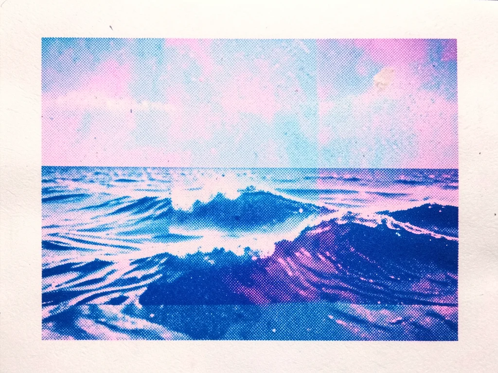 Risograph print of ocean waves in two-color blue separation, foam detail lost to
