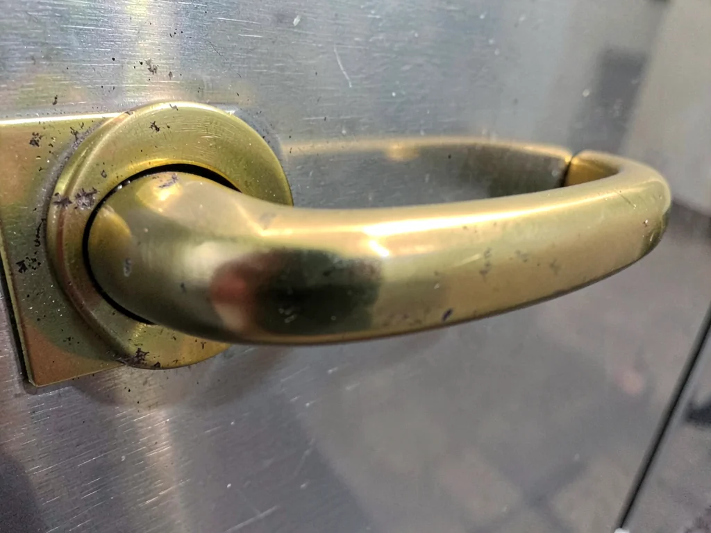 Brass door handle worn smooth