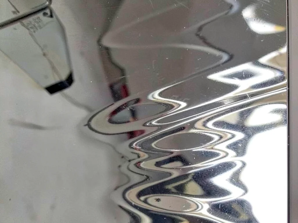 Silver mirror showing rippled image