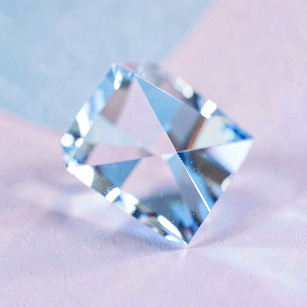 A 1cm tight crystal facet block sliced cleanly, cold blue trapped light glowing 