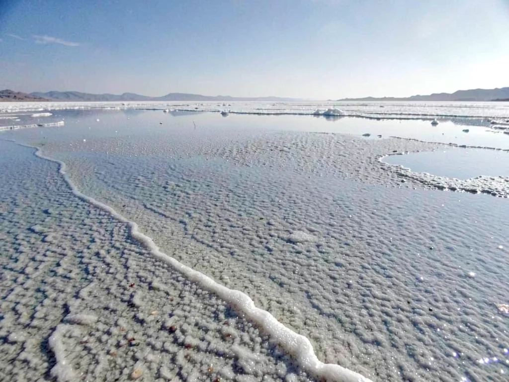 Salt texture visible through thin water layer