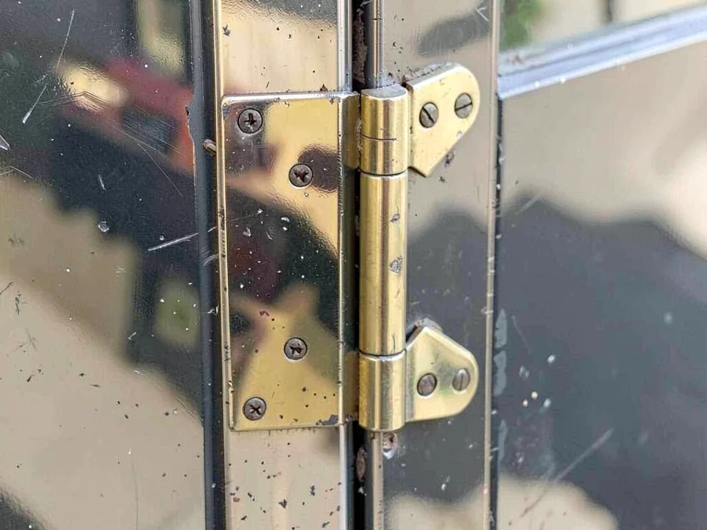 Brass hinges on old door