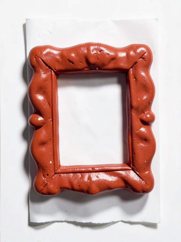Ornate chunky clay picture frame in cherry red with stubby cream-toned matte and