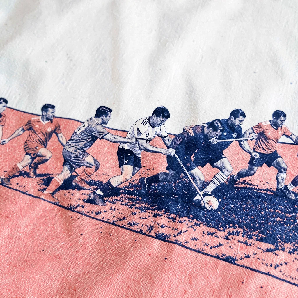 Two-color riso motif of a row of players linked in a maul over halftone turf in 