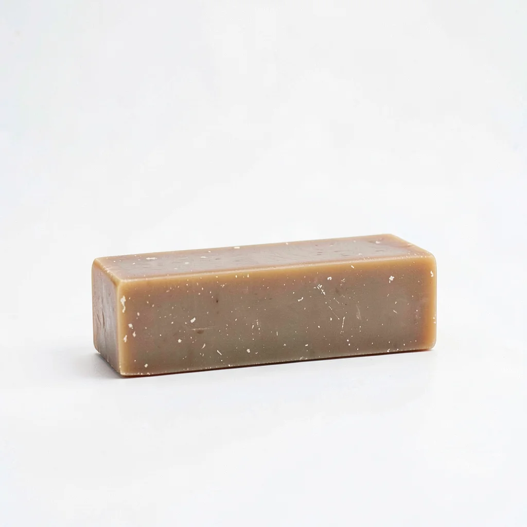 Minimal studio shot of a single bar of soap standing on its long edge on white s