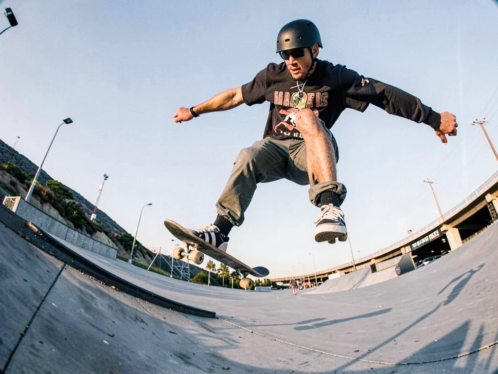 Skateboarder mid-trick with curved horizon