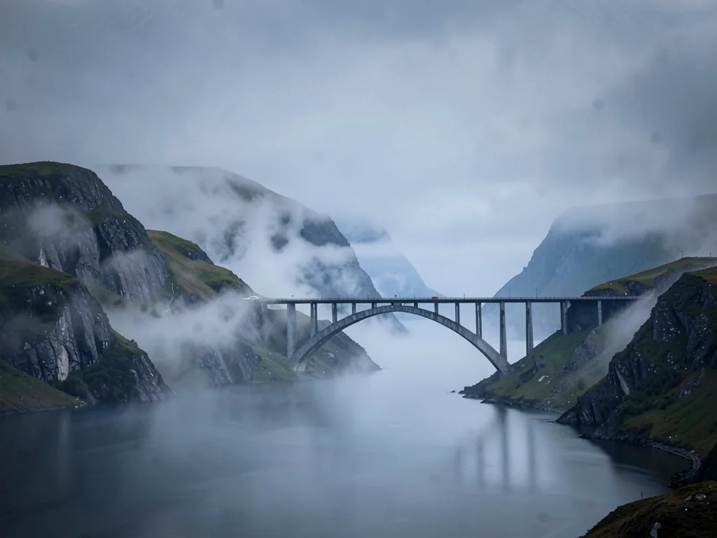Bridge span connecting ridges through mist