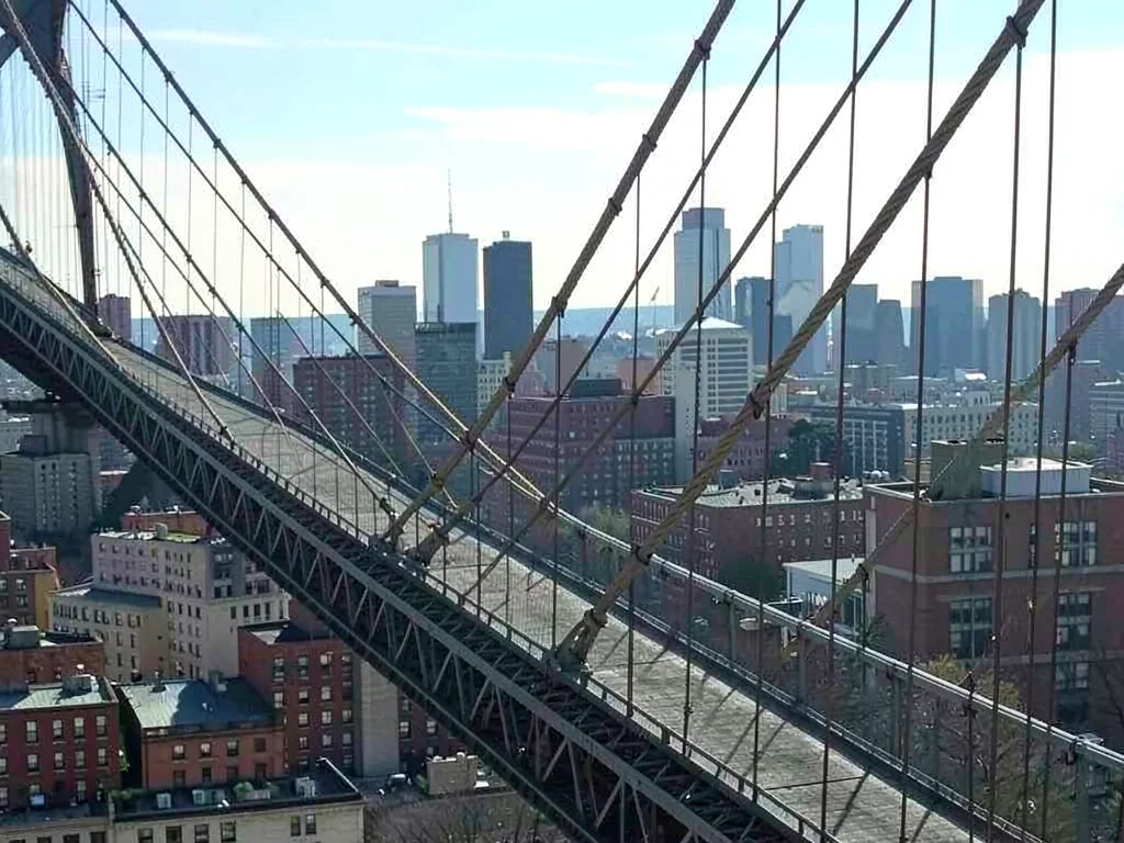 City skyline compressed behind bridge cables