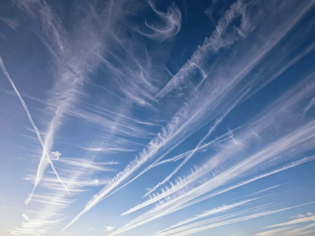 Cirrus wisps arranged in parallel streaks across gradient sky