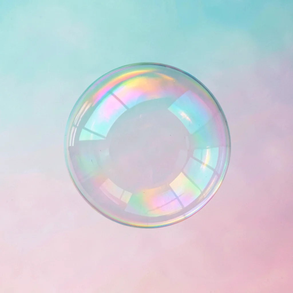 A single perfect soap bubble suspended dead-center against a tropical aqua-to-pi