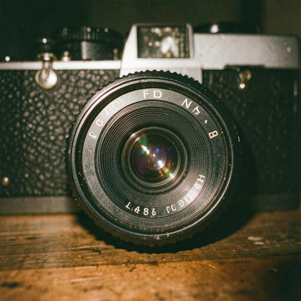 Vintage camera lens with aperture blades closing to f/8, iris pattern visible