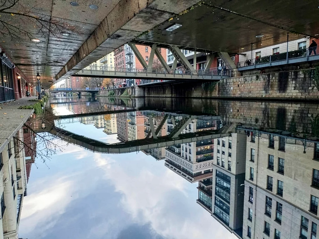 Bridge reflected in urban waterway