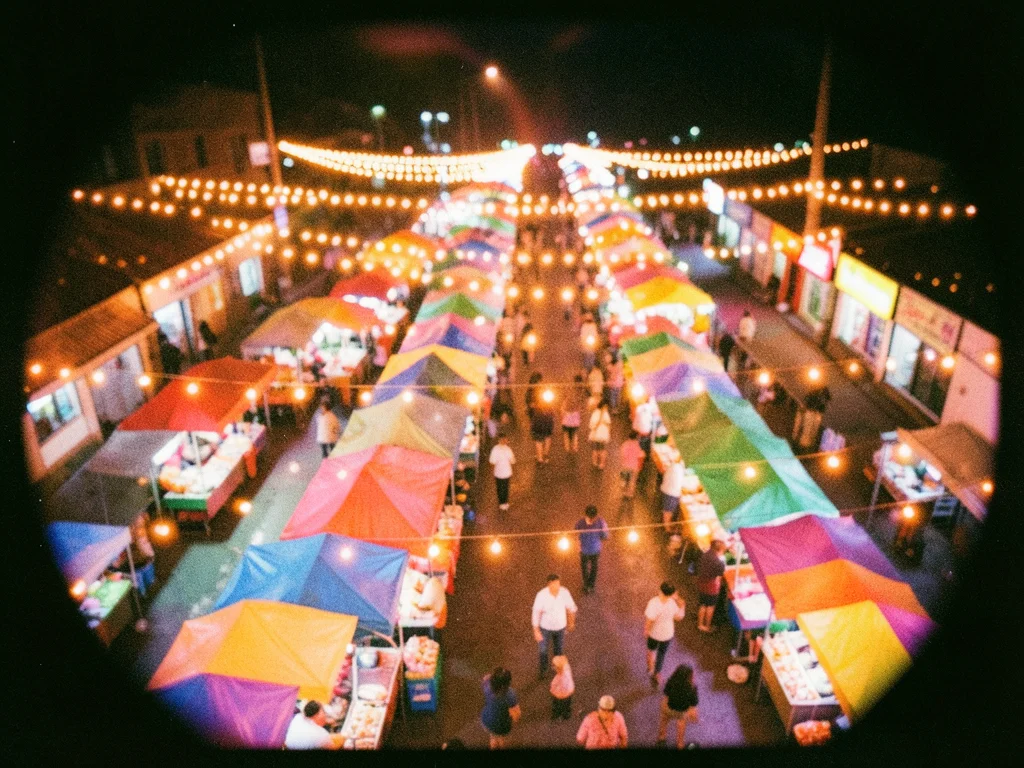 A night market from above, strings of lights creating warm bokeh orbs, the stall