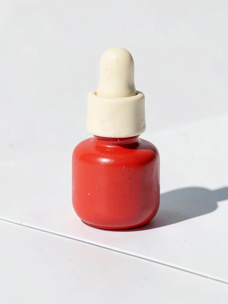 Hardy chunky clay nail polish bottle in cherry red with stubby cream-toned brush