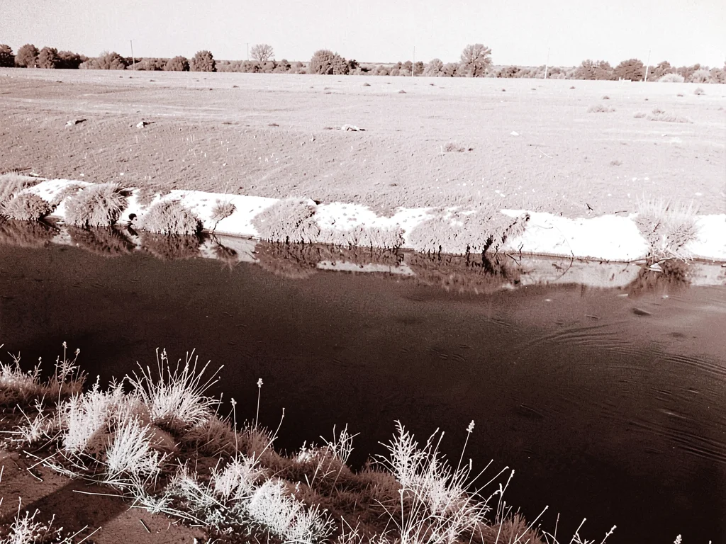 River with white banks dark water
