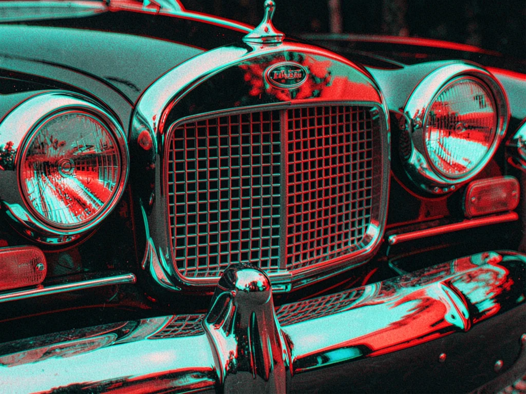A vintage car front grille and headlights close-up with red-cyan offset emphasiz