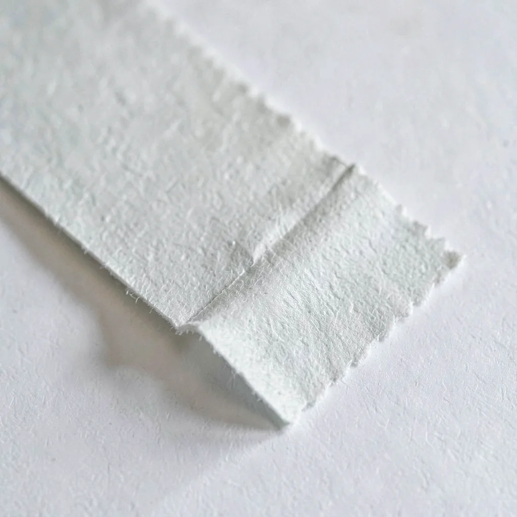 Paper-fold study of a folded sandpaper sheet creased to the grit edge