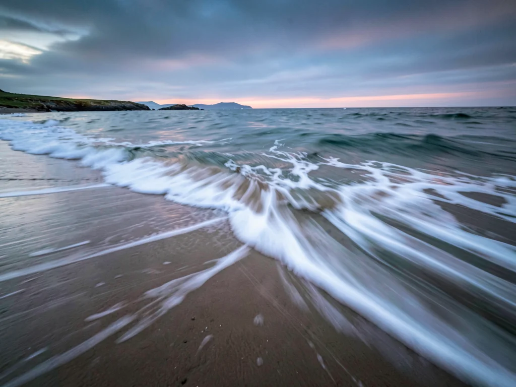 Retreating wave leaving soft blur on sand