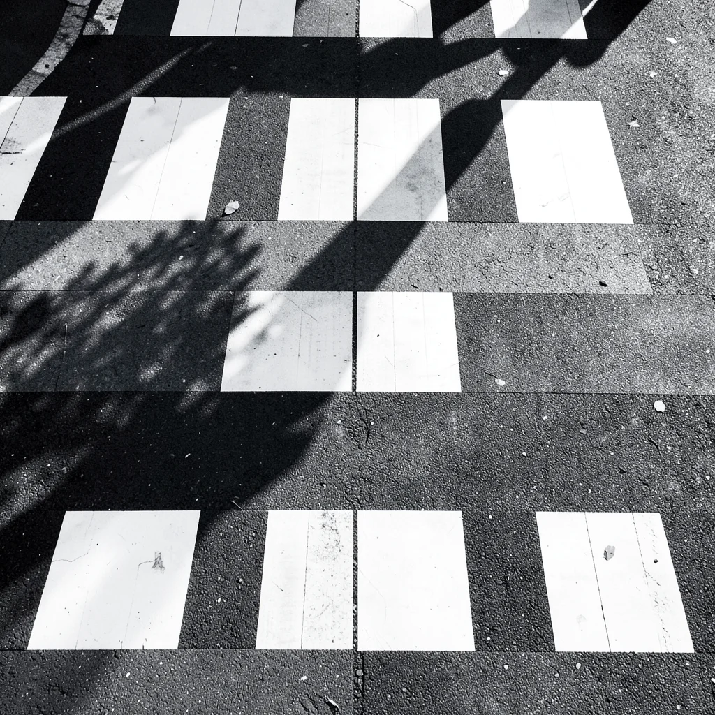Crosswalk stripes and shadows forming piano keys pattern, overhead view