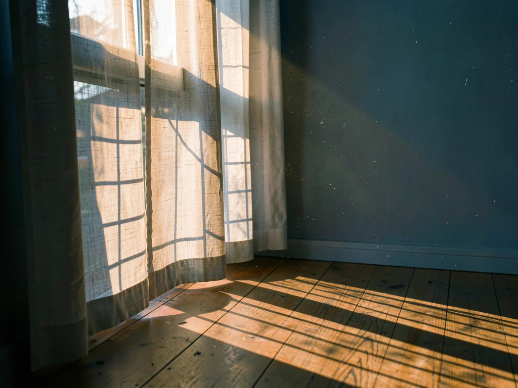 Geometric shadow pattern on bare morning floor