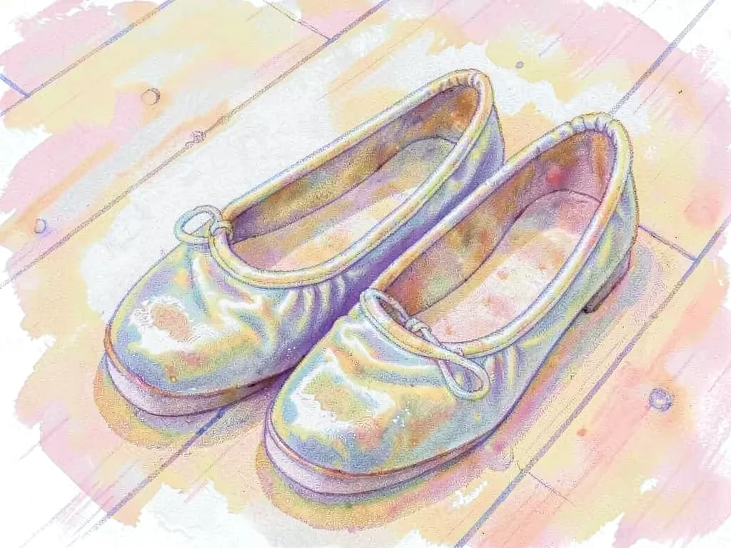 Worn ballet slippers on wooden floor