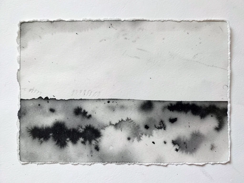 Monoprint edge where plate meets paper, sharp boundary between inked image and b