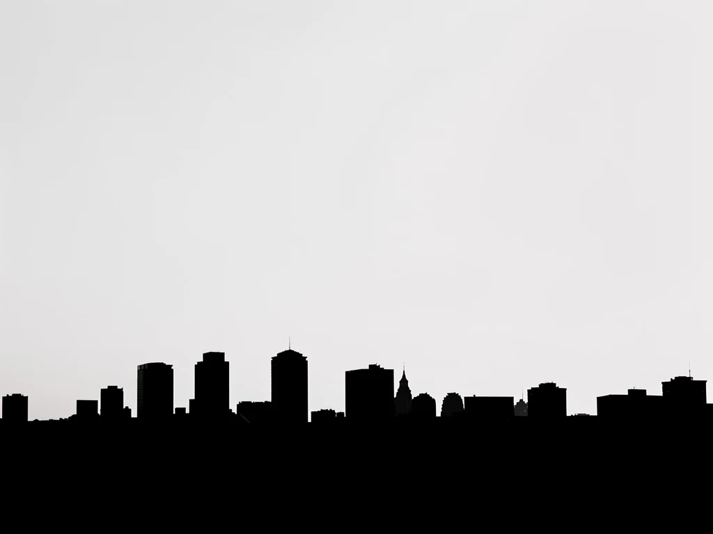 City skyline solarized at the horizon line, buildings become negative space and 