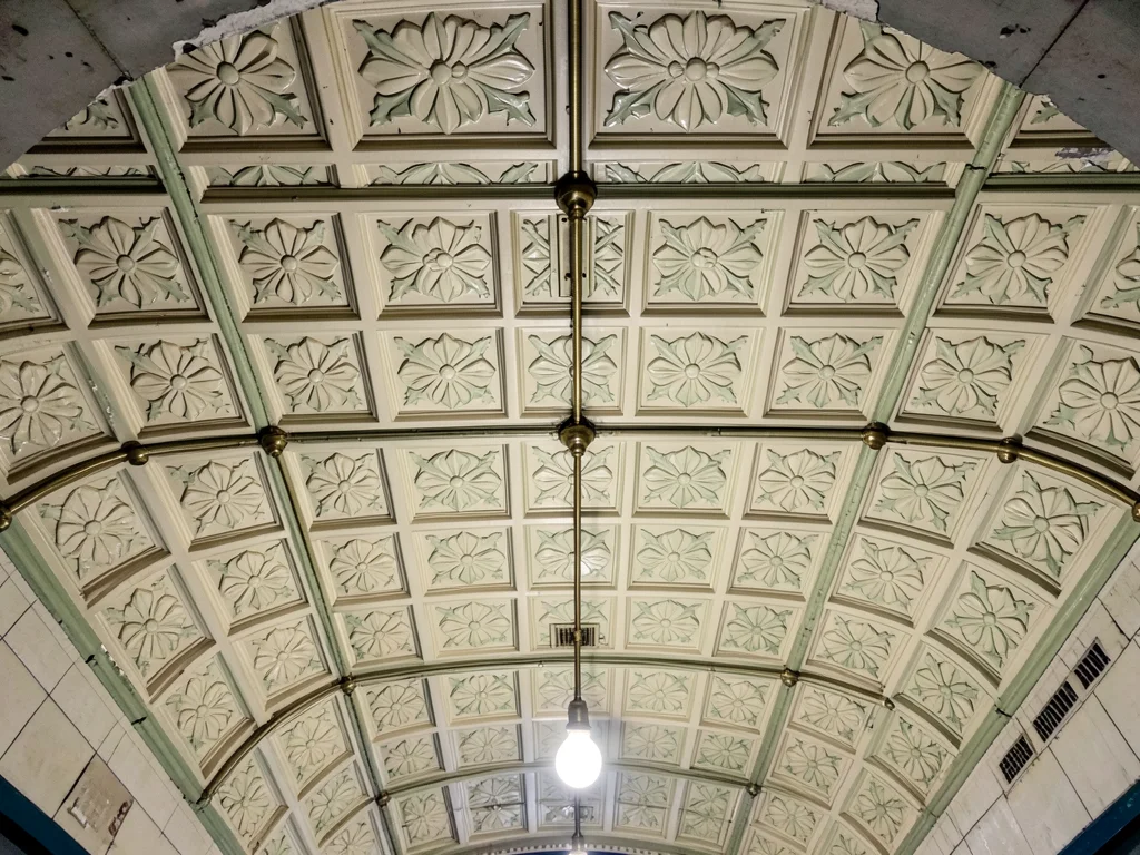 The ceiling of an Art Nouveau Budapest metro station, ornate pressed tin panels 