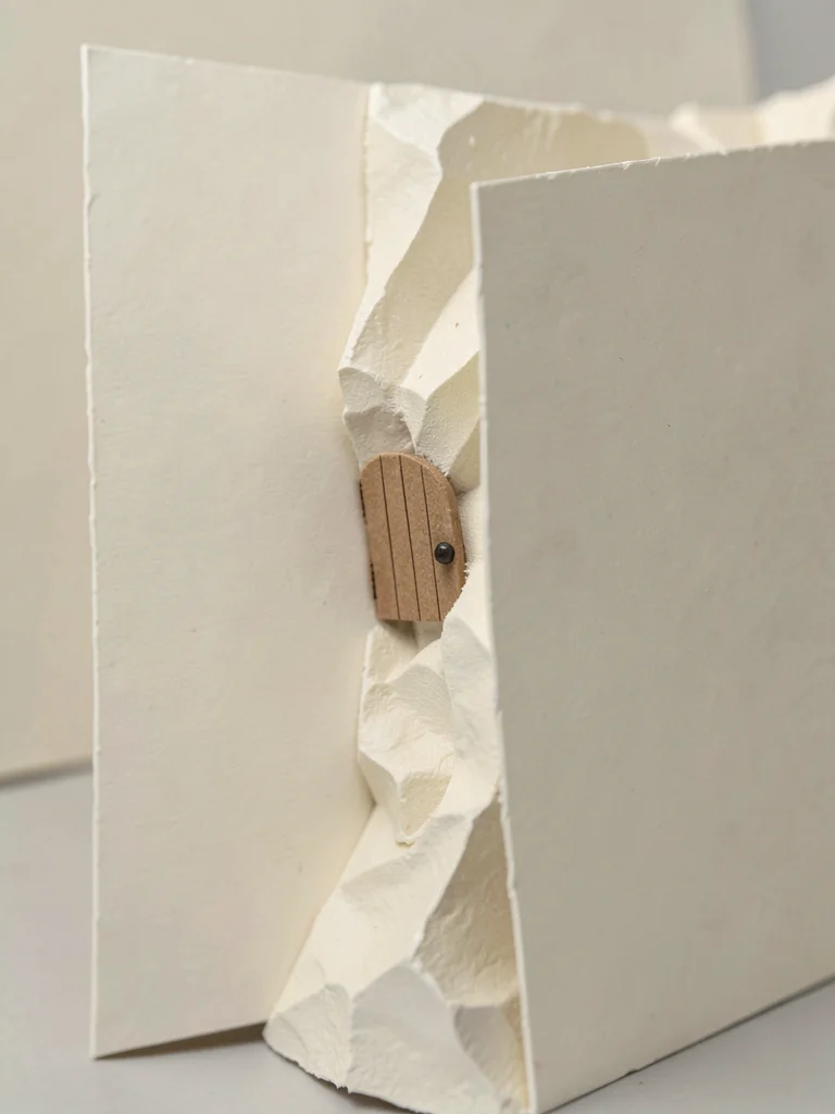 The tiny papercraft door installs flush in the side of a much larger flat cardst