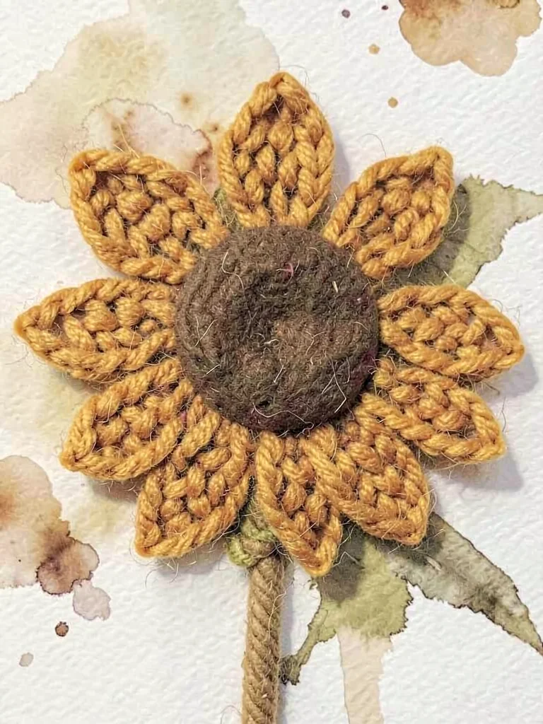 Bristled mustard knit sunflower with chunky-knit petals around a felted brown ce