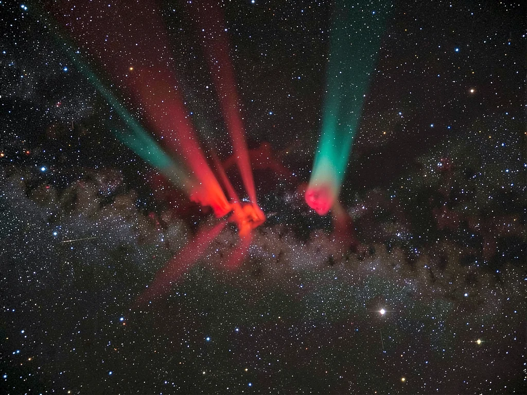 An emission nebula in narrowband false color — hydrogen-alpha pillars in deep re