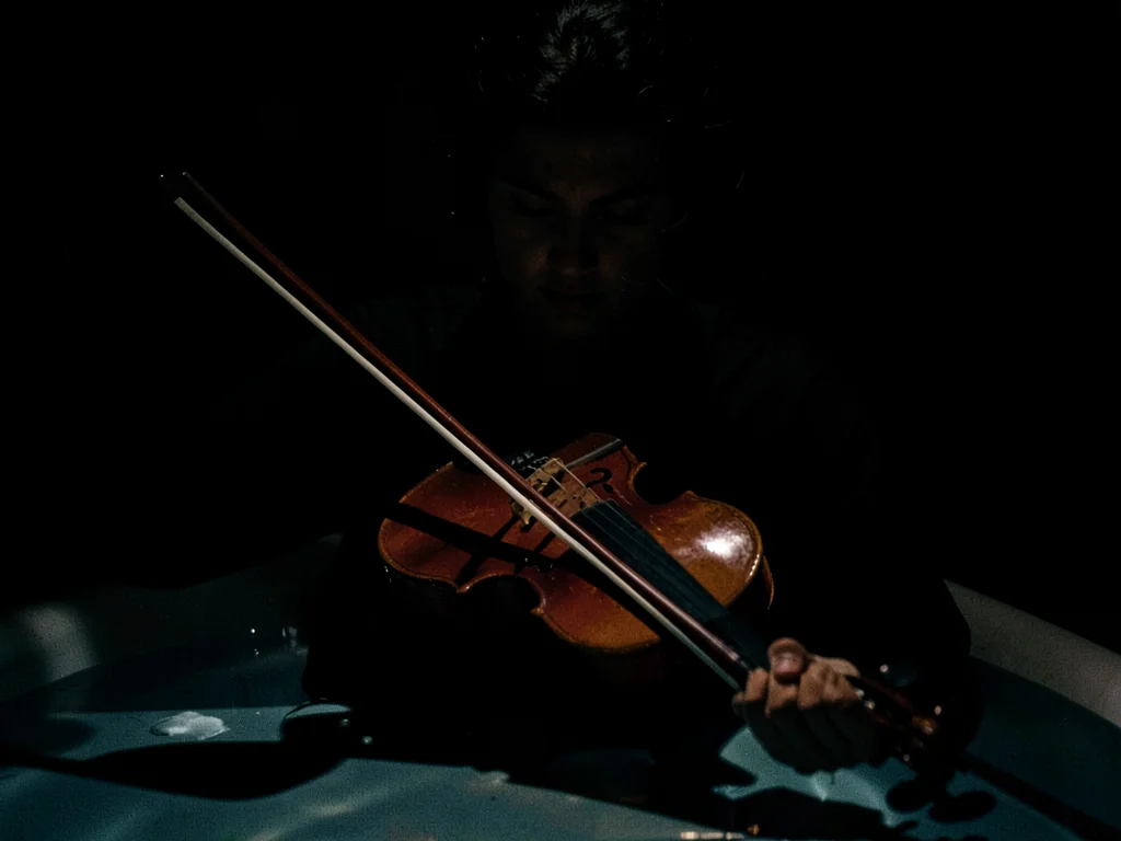 Violin and bow in pool of light