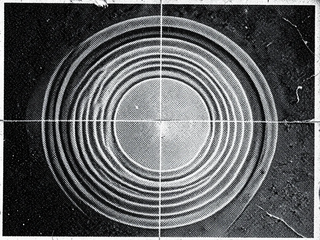Moiré interference pattern from photocopying a halftone newspaper image, concent