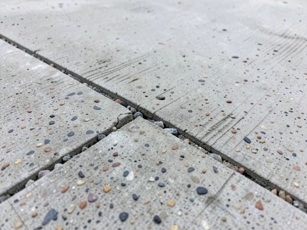 Expansion joint in concrete slab, deliberate crack with sealant, geometric line 