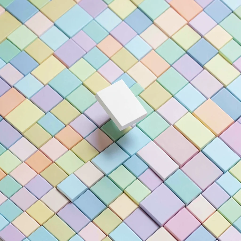 Top-down isometric grid of pastel cube tiles arranged in a clean checkerboard wi