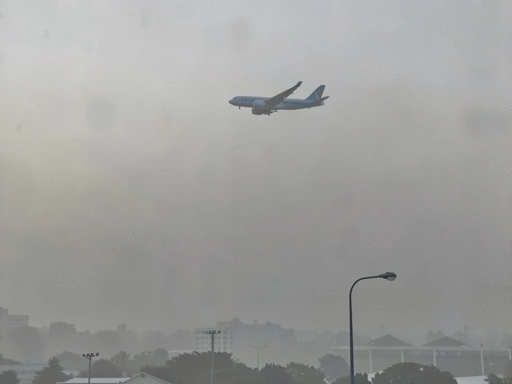 Aircraft visible above smog