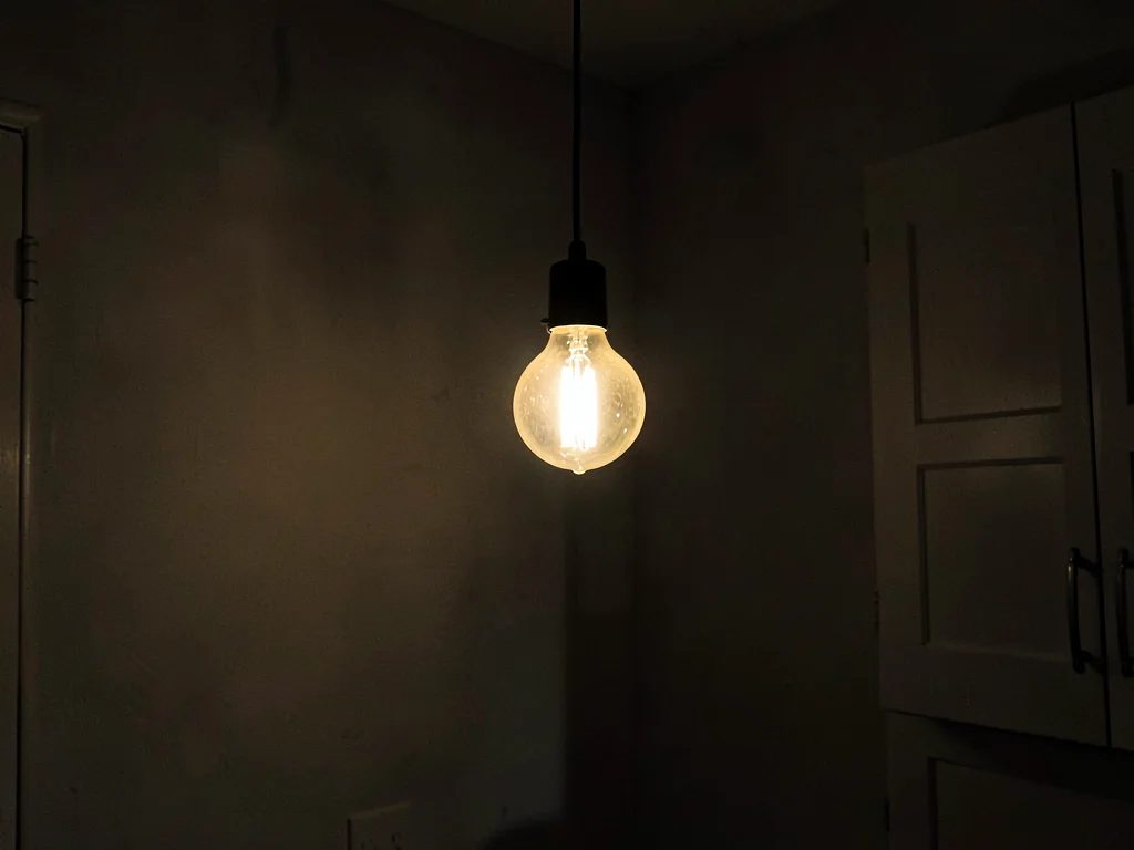 Single bare bulb illuminating room