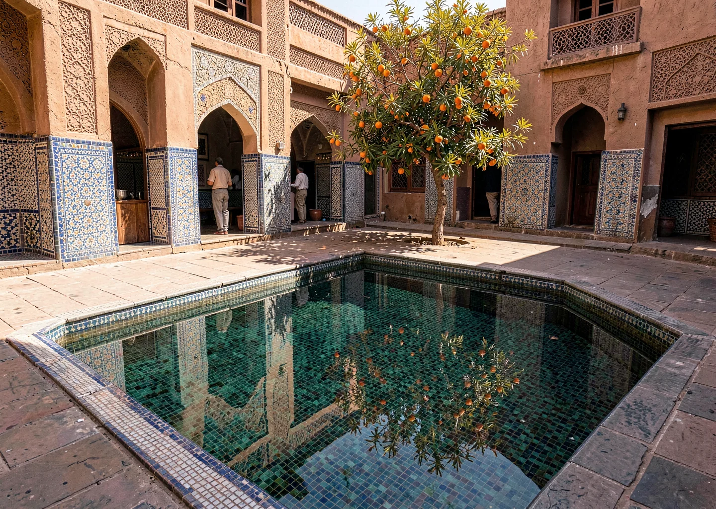 Geometric shadow play in Marrakech medina, mosaic pool with orange tree reflecti