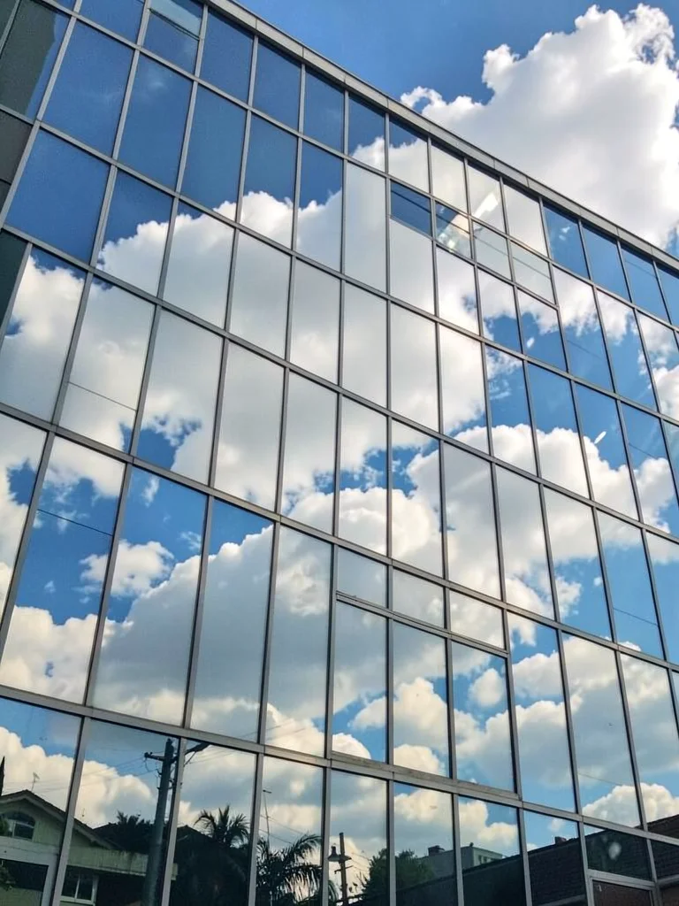 Glass facade reflecting sky