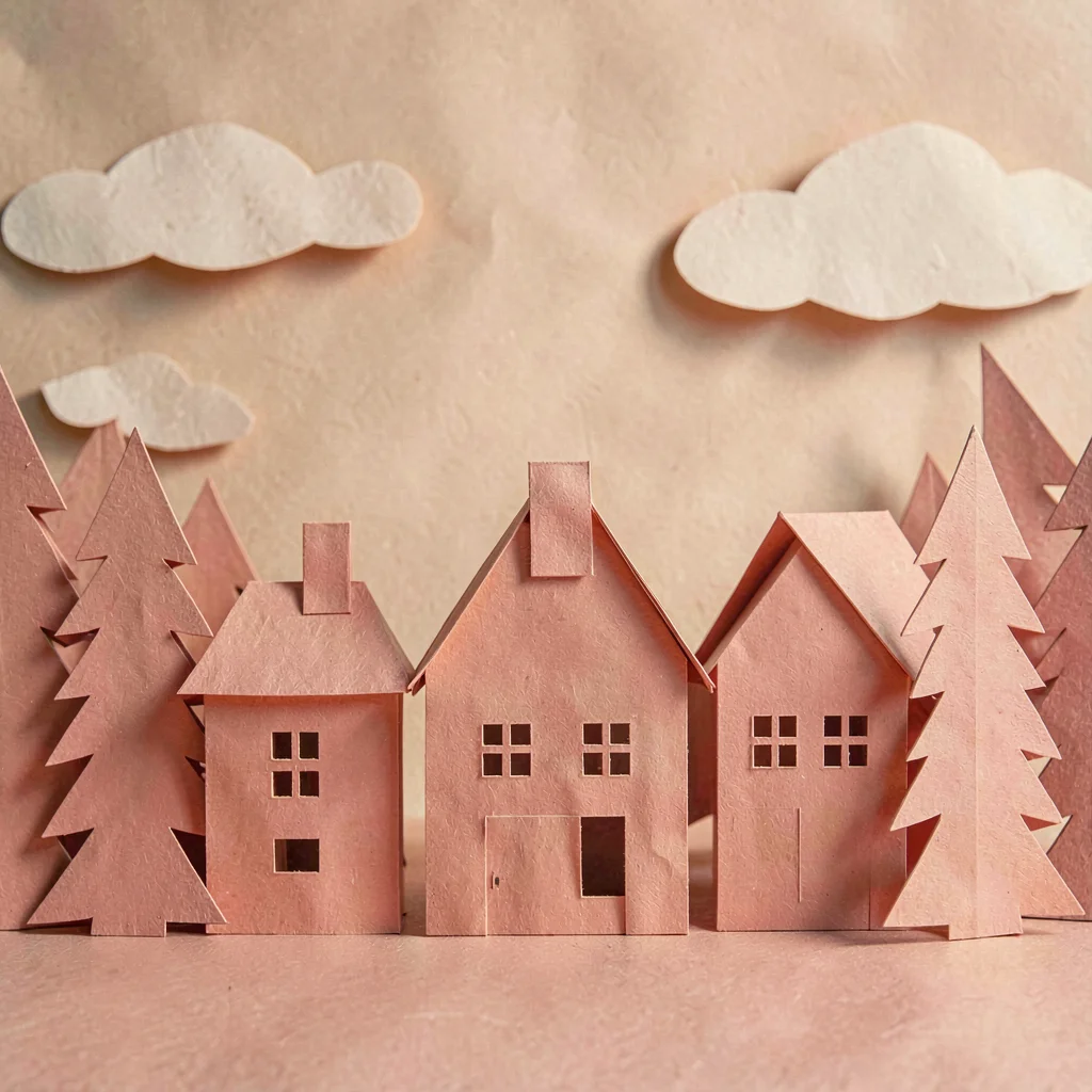 Papercraft composition of layered paper-cut chimneys against folded paper sky, w