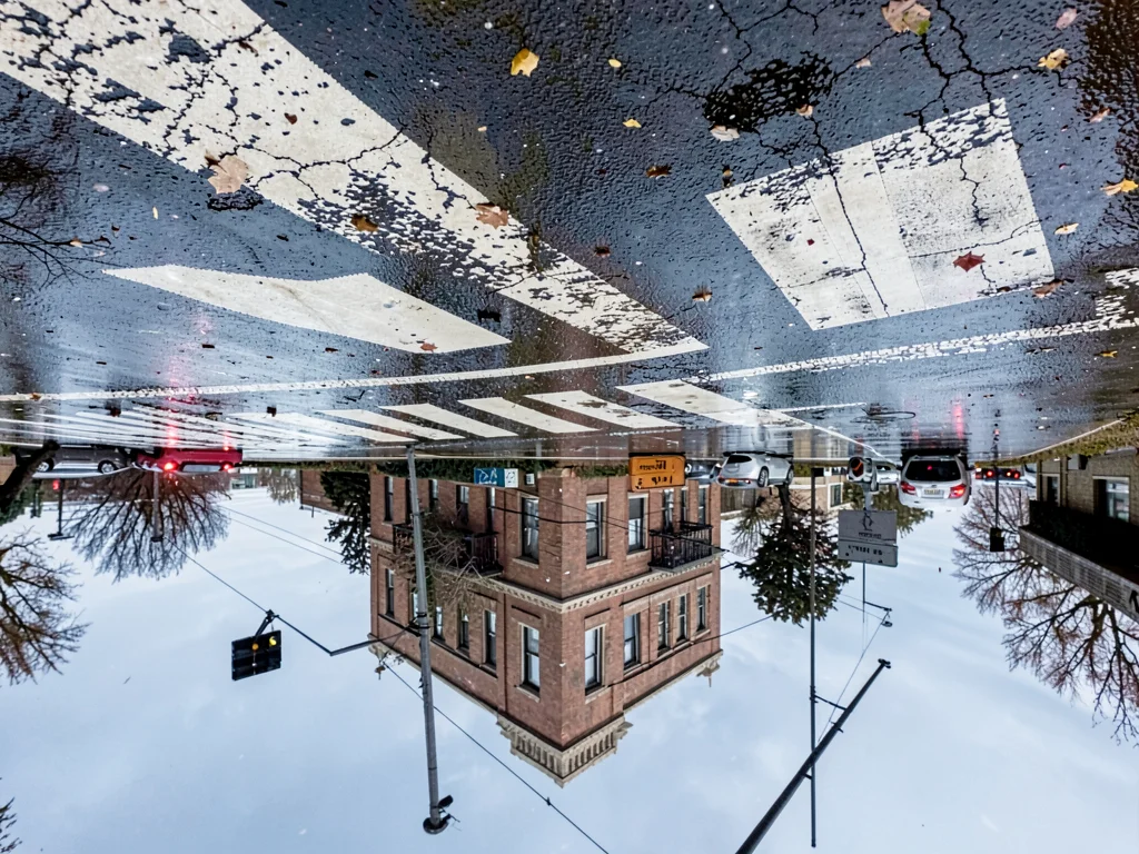 Crosswalk reflected in wet intersection