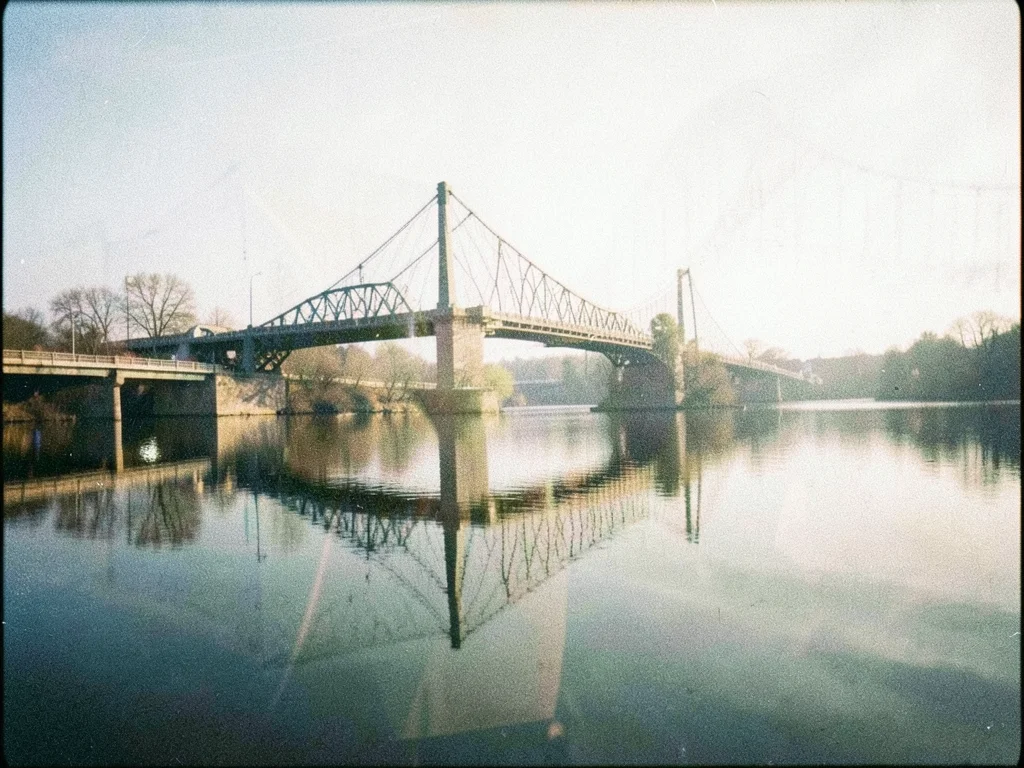 A bridge double-exposed with its reflection, the real and reflected versions sli