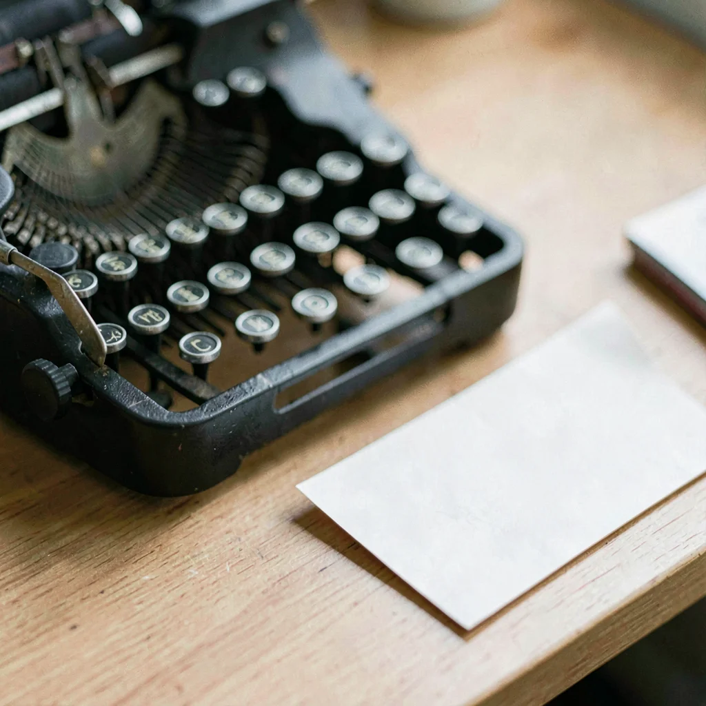 Macro of a typewriter ribbon and a folded paper note on a desk