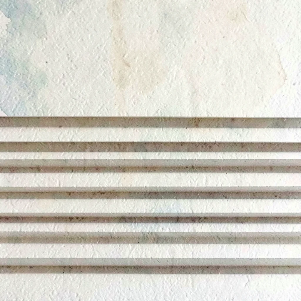 A series of horizontal paper-folds creates rhythmic creases across the lower-hal