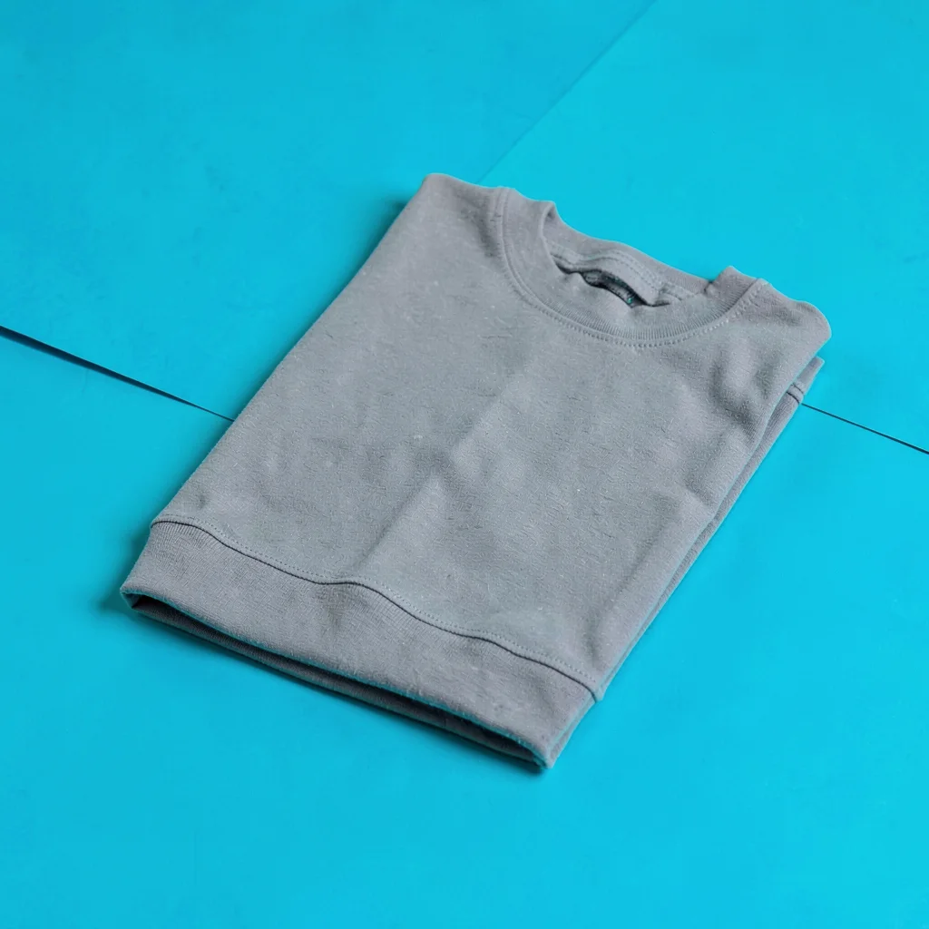 single matte-grey knee-support sleeve folded flat at three-quarter on a saturate